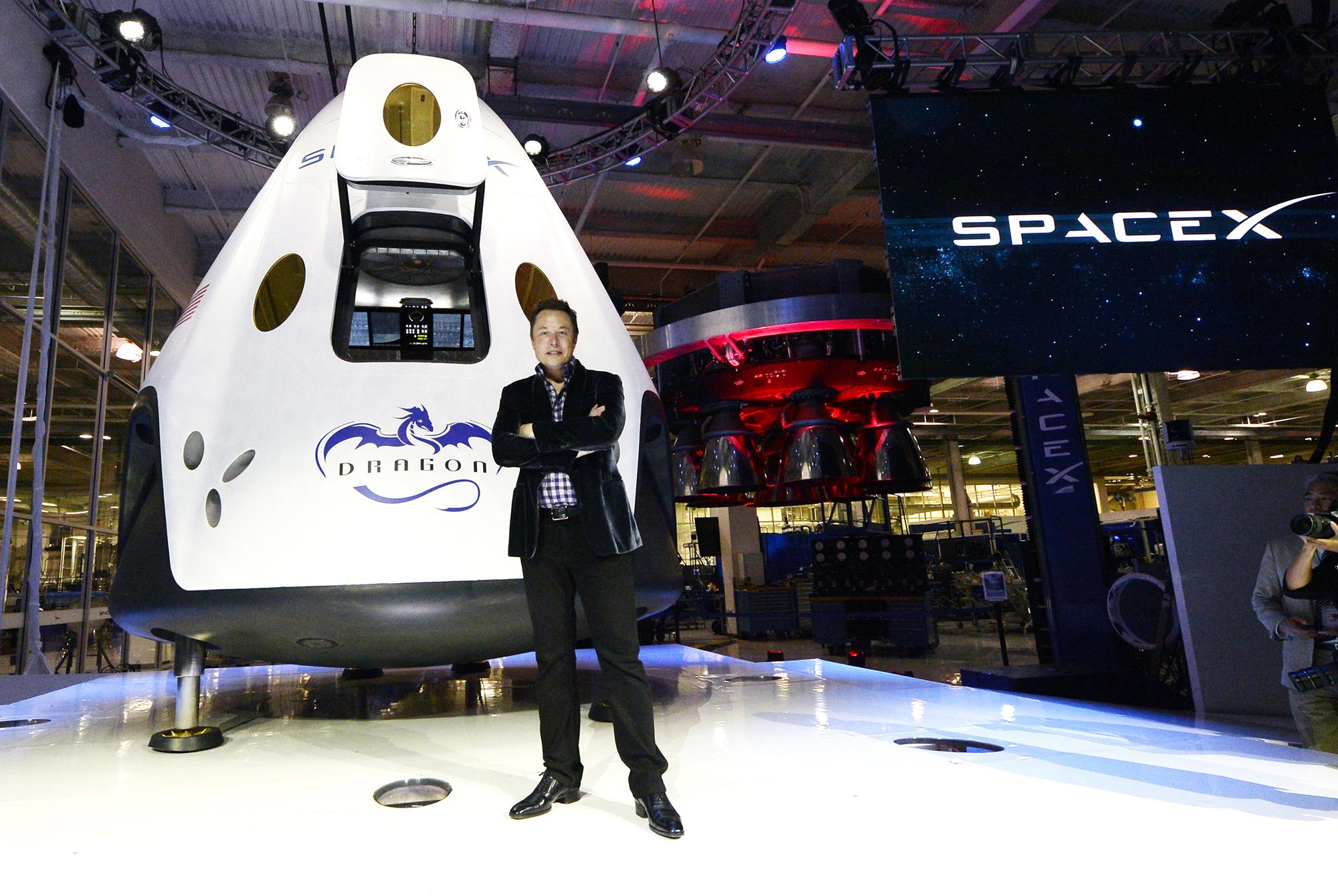 HAWTHORNE-CA-MAY 29: SpaceX CEO Elon Musk unveils the company's new manned spacecraft, The Dragon V2, designed to carry astronauts into space during a news conference on May 29, 2014, in Hawthorne, California. The private spaceflight company has been flying unmanned capsules to the Space Station delivering cargo for the past two years. The Dragon V2 manned spacecraft will ferry up to seven astronauts to low-Earth orbit. (Photo by Kevork Djansezian/Getty Images)