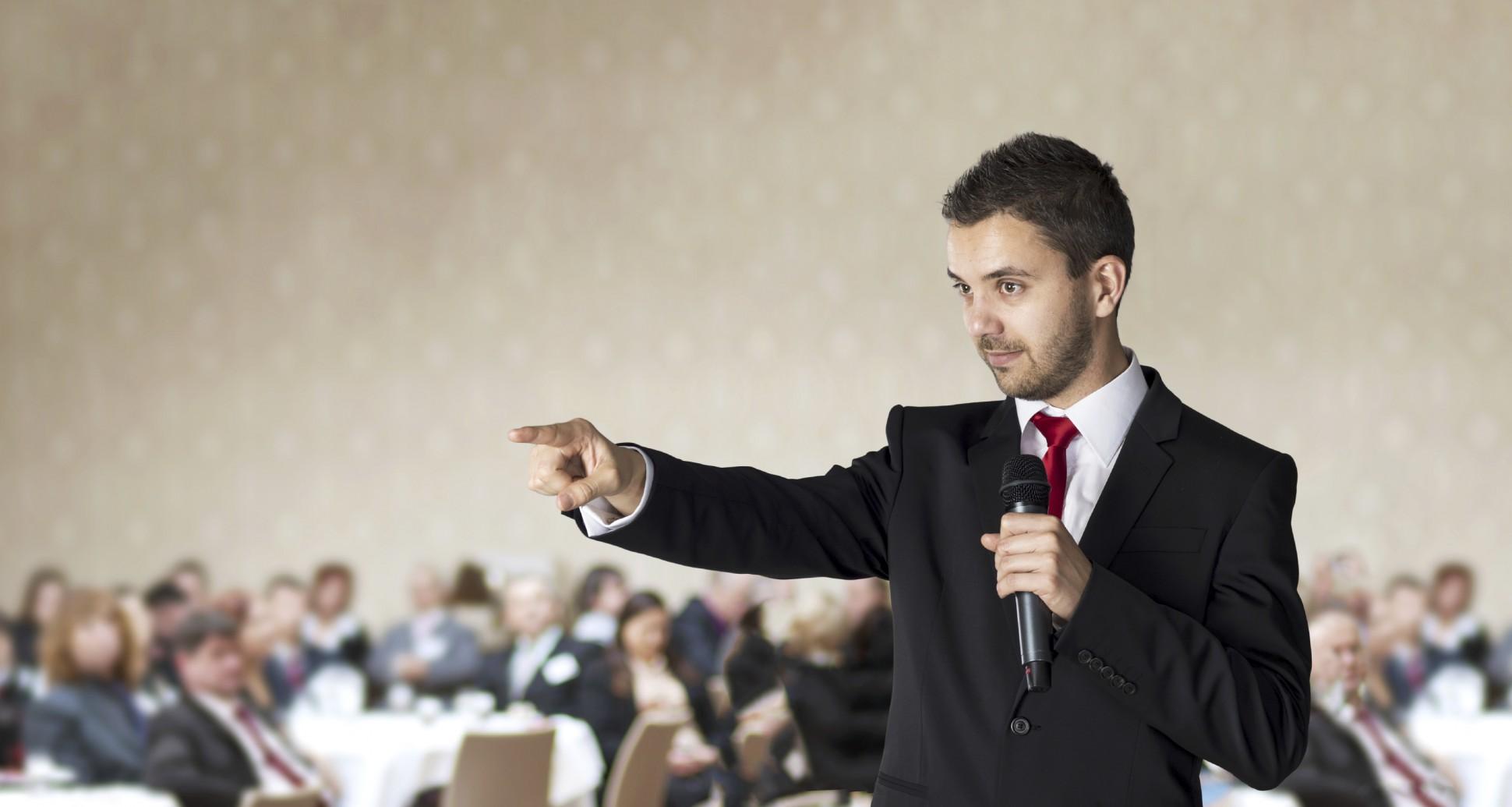 Man-speaking-at-event-1940x1035